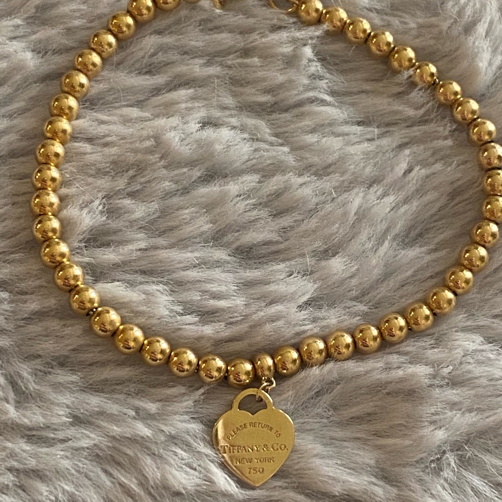Tiffany & Co. gold heart charm bracelet.